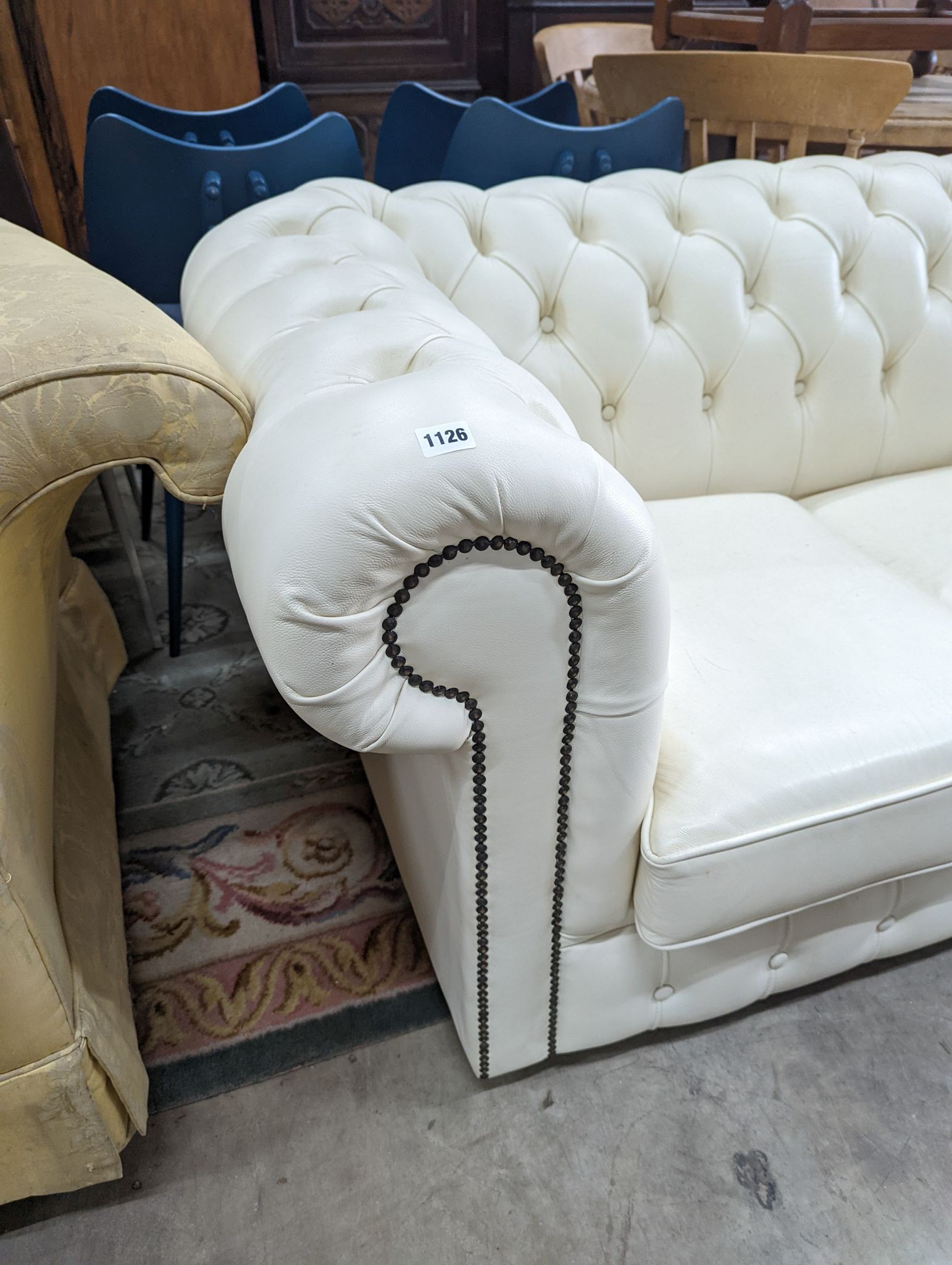 A Victorian style buttoned white leather Chesterfield settee, length 190cm, depth 86cm, height 72cm